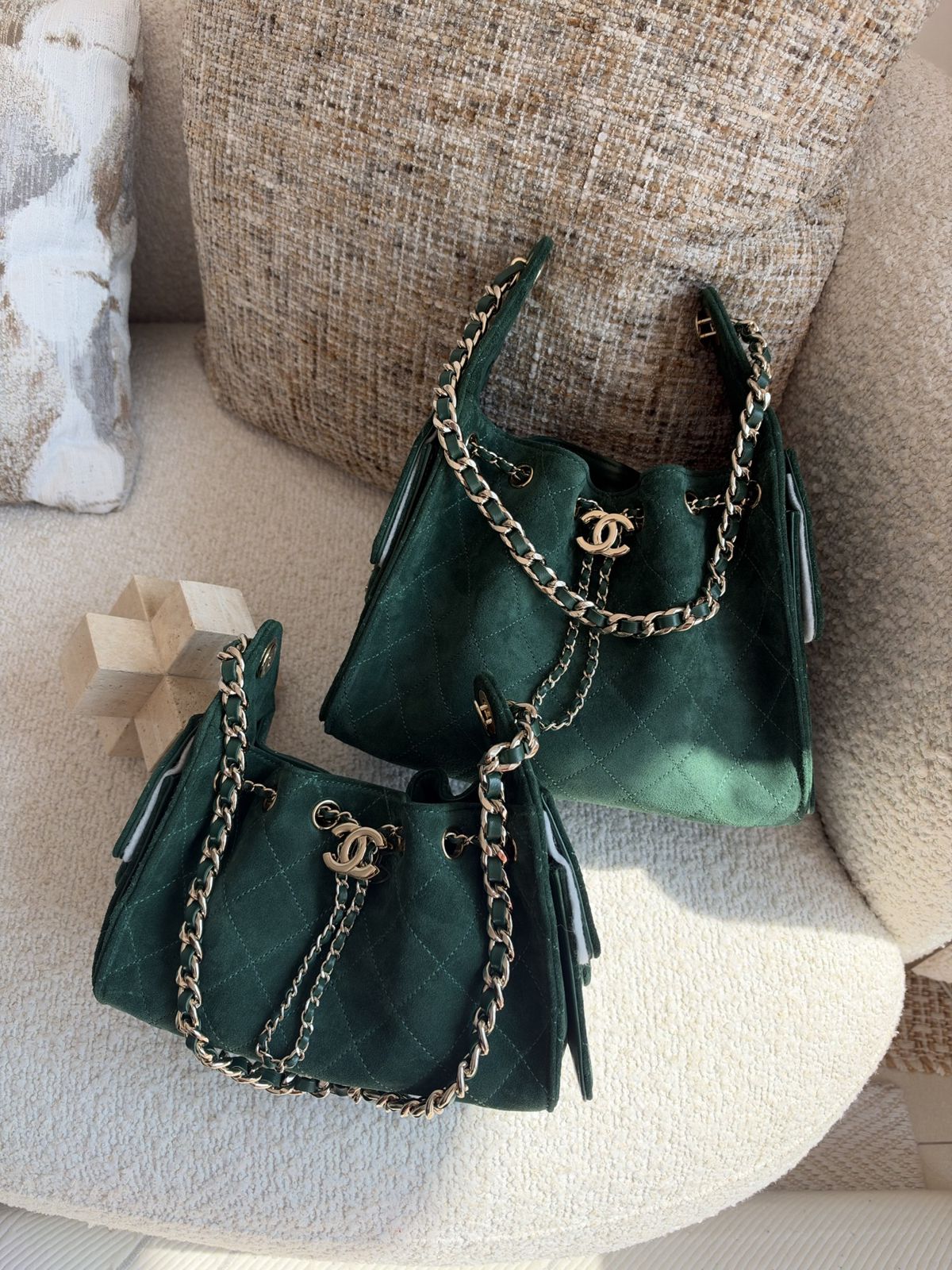 Two emerald suede drawstring bucket bags